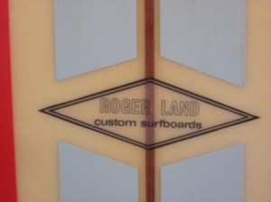 Roger Land logo on long board