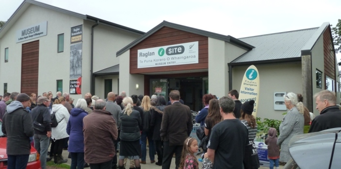 The crowd at the exhibition opening moves into the Museum